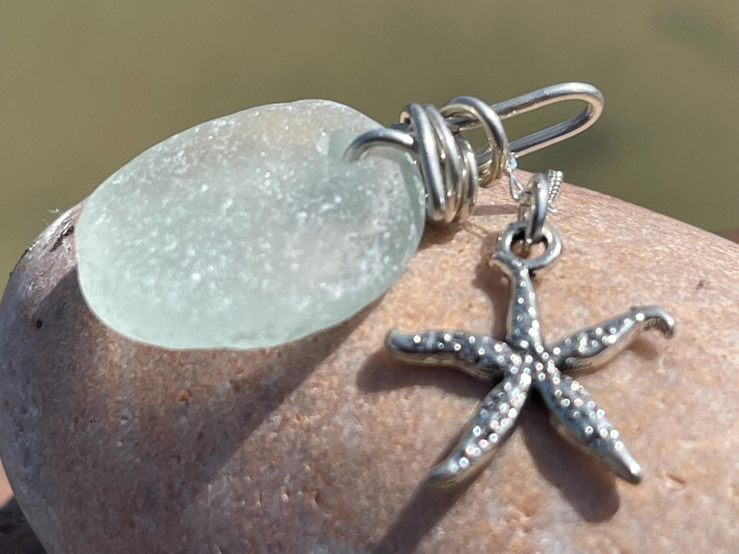 Eco friendly sea glass necklace on a sterling silver chain showcasing a little starfish pendant, starfish necklace, ethical jewellery