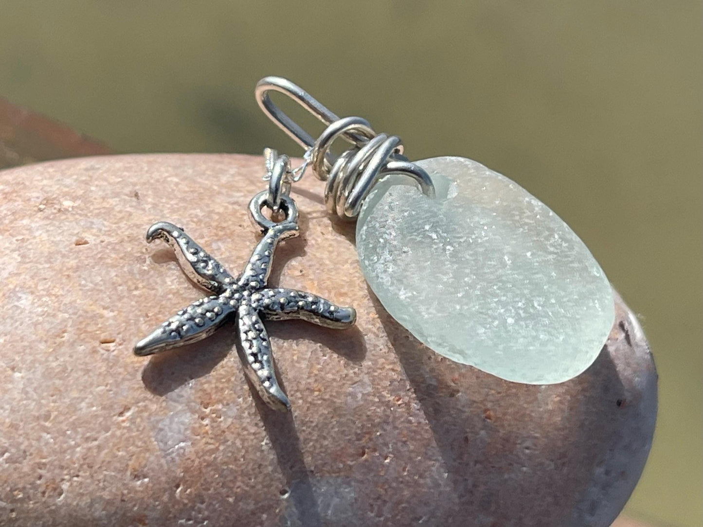 Eco friendly sea glass necklace on a sterling silver chain showcasing a little starfish pendant, starfish necklace, ethical jewellery