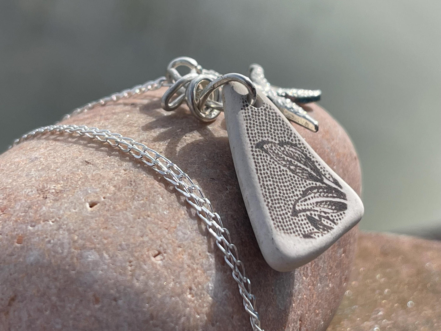 Eco friendly sea ceramic necklace on a sterling silver chain showcasing a little starfish pendant, starfish necklace, ethical jewellery