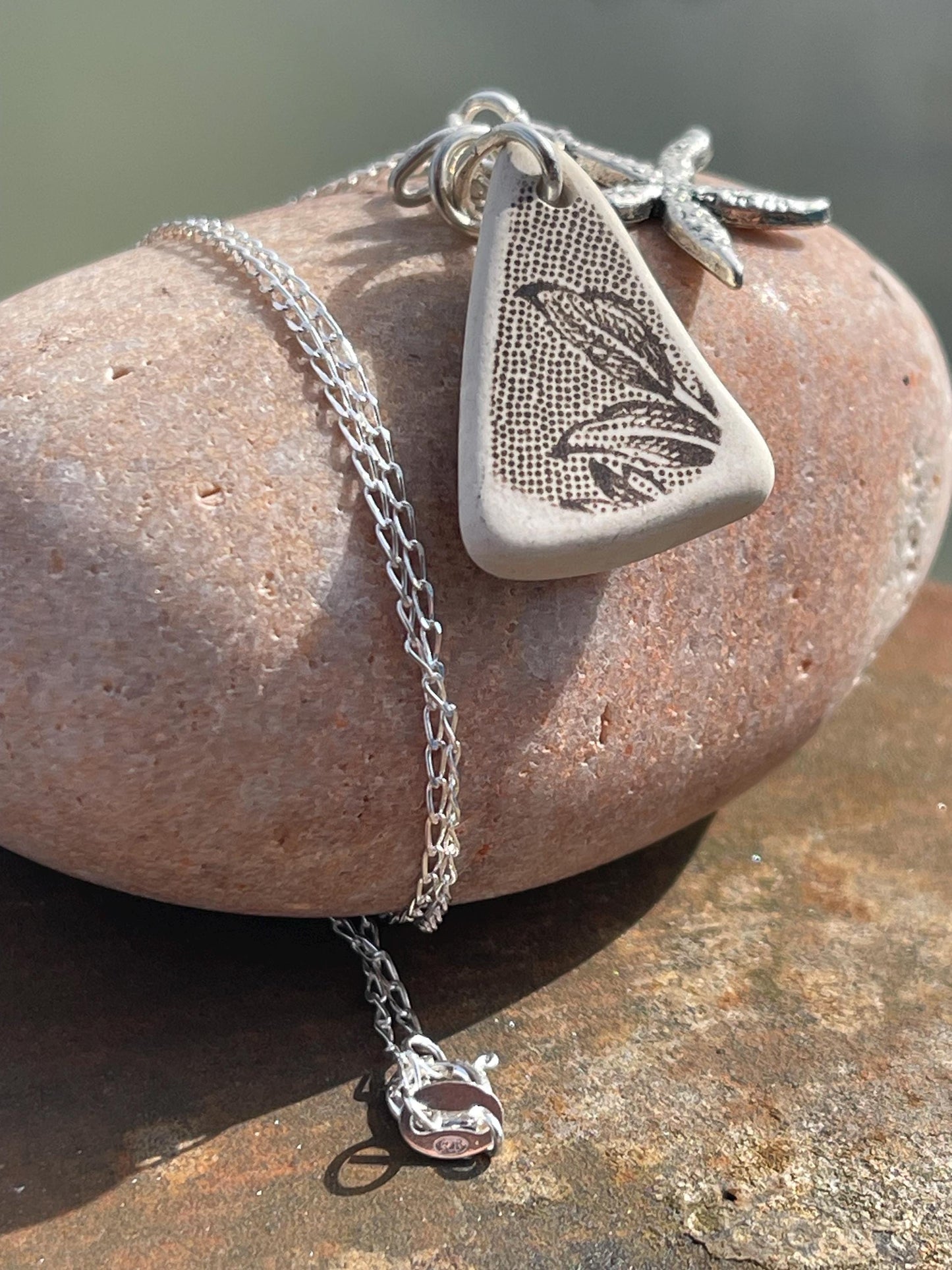 Eco friendly sea ceramic necklace on a sterling silver chain showcasing a little starfish pendant, starfish necklace, ethical jewellery