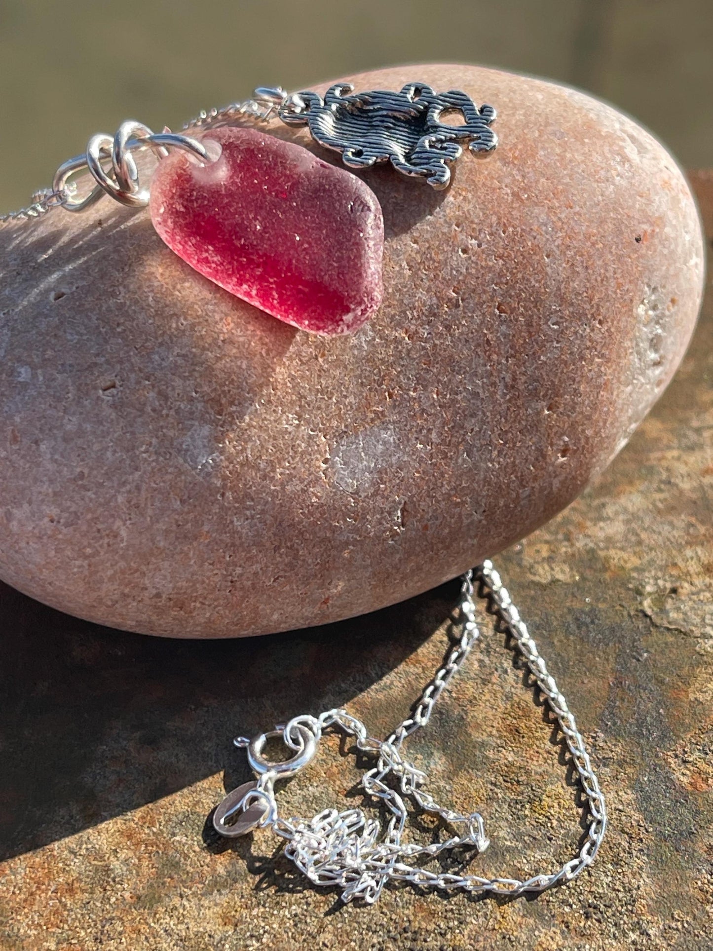Eco friendly sea glass necklace on a sterling silver chain showcasing a little octopus. Octopus pendant, octopus necklace, ethical jewellery