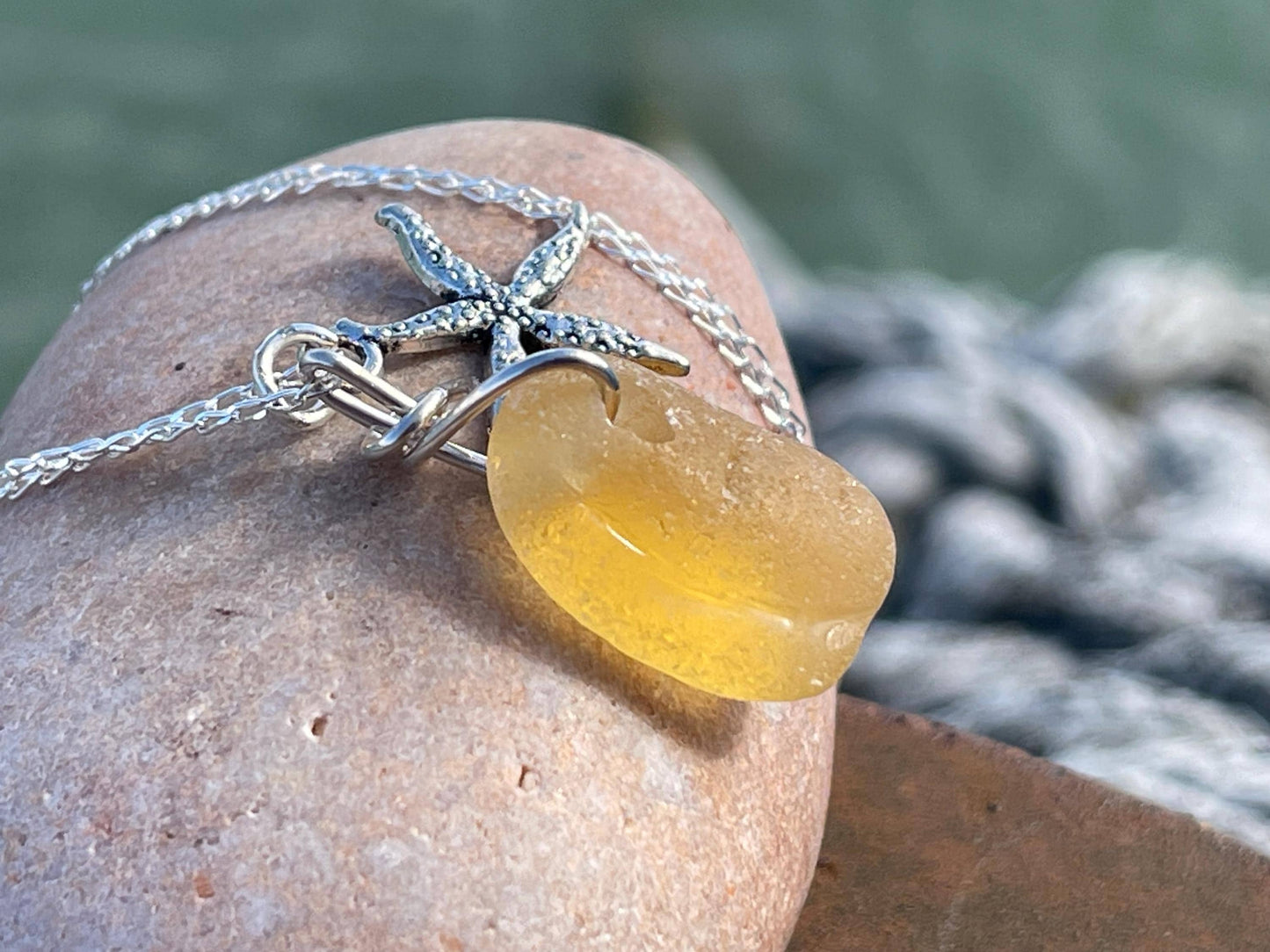 Eco friendly sea glass necklace on a sterling silver chain showcasing a little starfis. Starfish pendant, octopus necklace, eco jewellery