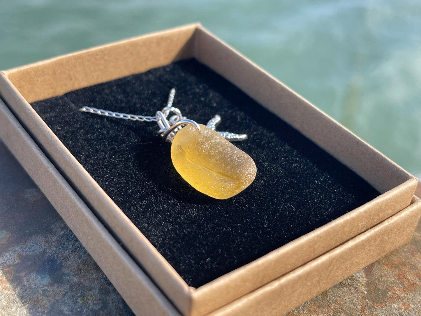 Eco friendly sea glass necklace on a sterling silver chain showcasing a little starfis. Starfish pendant, octopus necklace, eco jewellery