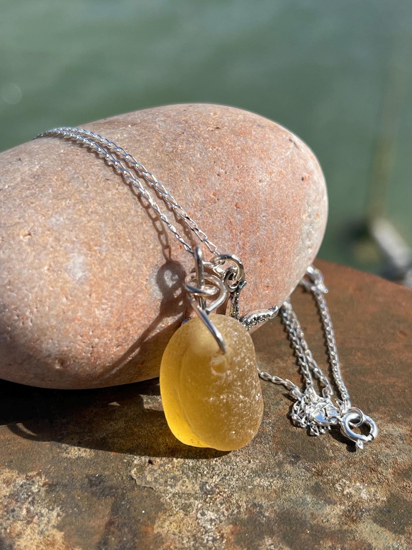 Eco friendly sea glass necklace on a sterling silver chain showcasing a little starfis. Starfish pendant, octopus necklace, eco jewellery