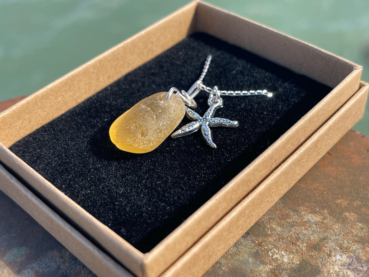 Eco friendly sea glass necklace on a sterling silver chain showcasing a little starfis. Starfish pendant, octopus necklace, eco jewellery
