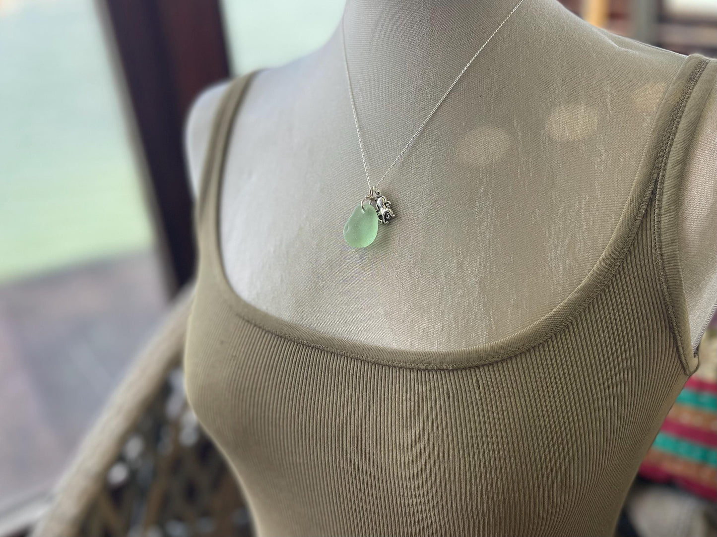 Eco friendly sea glass necklace on a sterling silver chain showcasing a little octopus. Octopus pendant, octopus necklace, eco jewellery