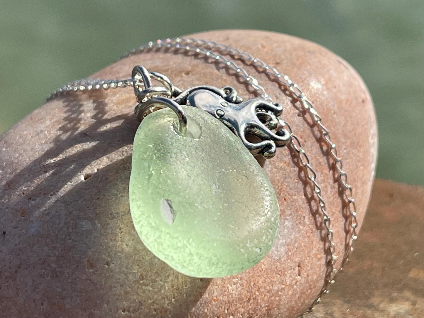 Eco friendly sea glass necklace on a sterling silver chain showcasing a little octopus. Octopus pendant, octopus necklace, eco jewellery