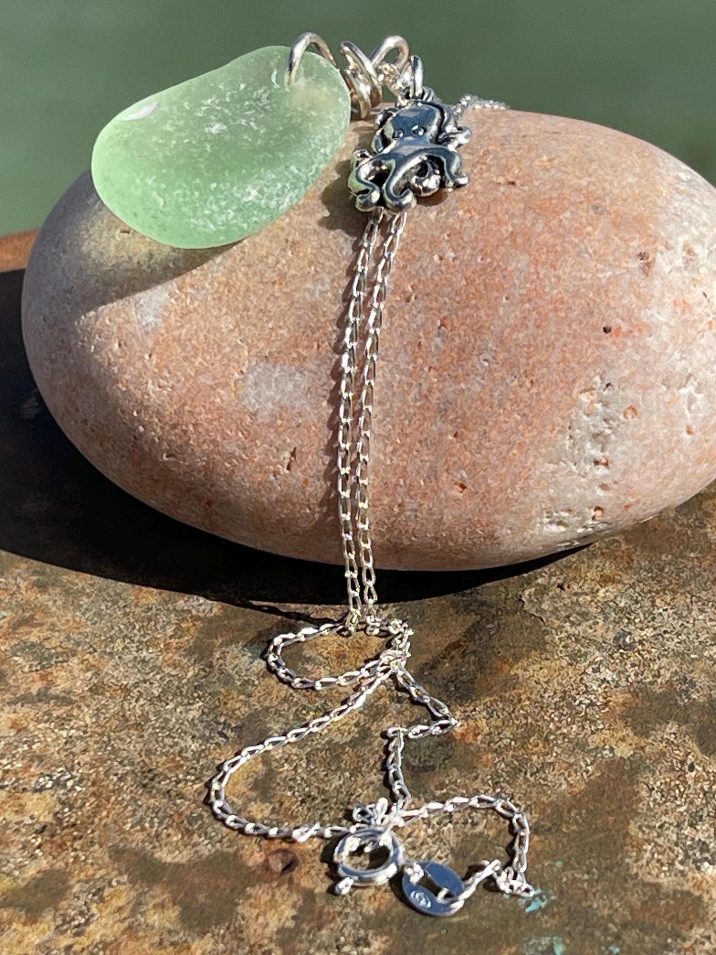 Eco friendly sea glass necklace on a sterling silver chain showcasing a little octopus. Octopus pendant, octopus necklace, eco jewellery