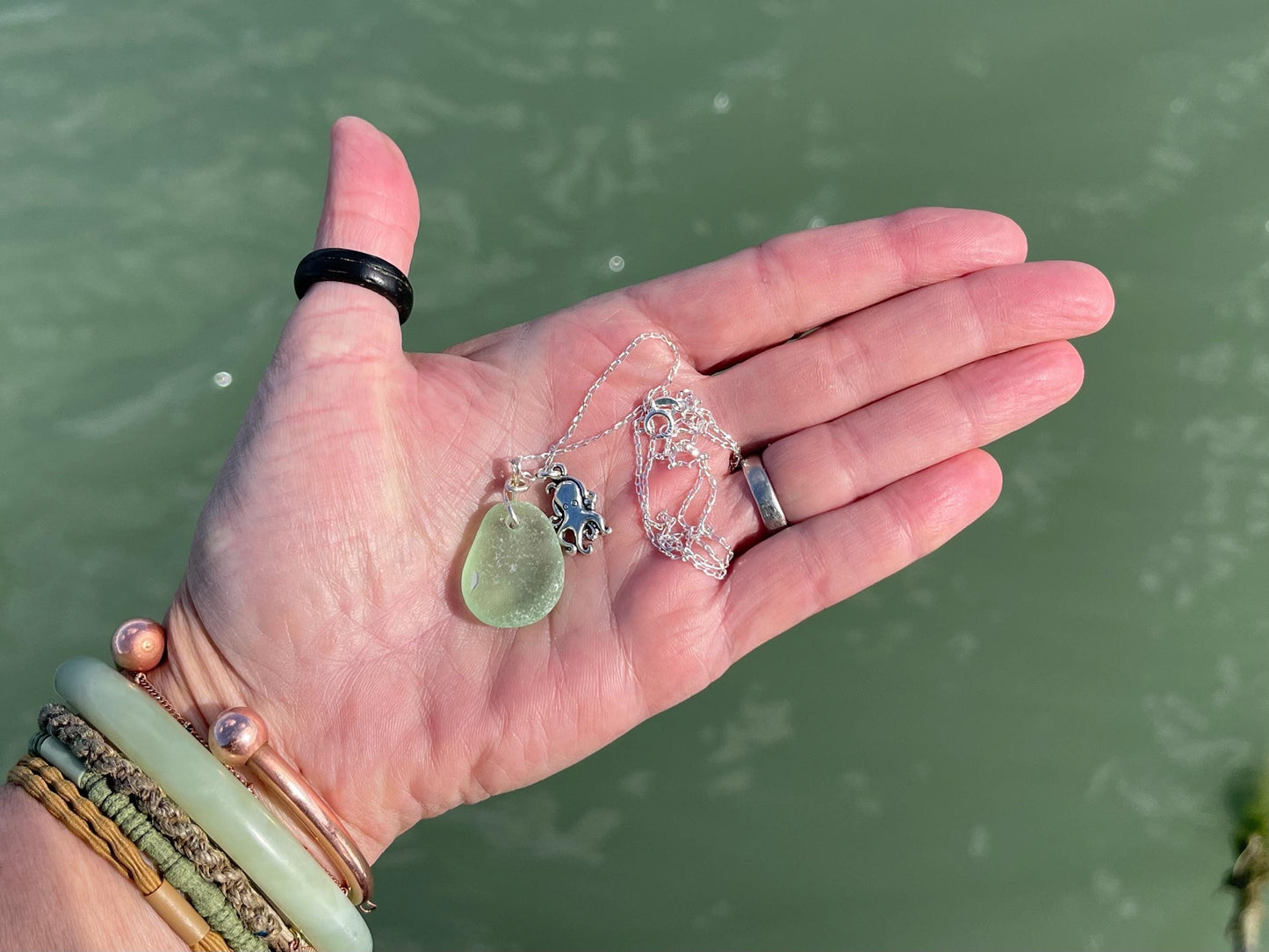 Eco friendly sea glass necklace on a sterling silver chain showcasing a little octopus. Octopus pendant, octopus necklace, eco jewellery