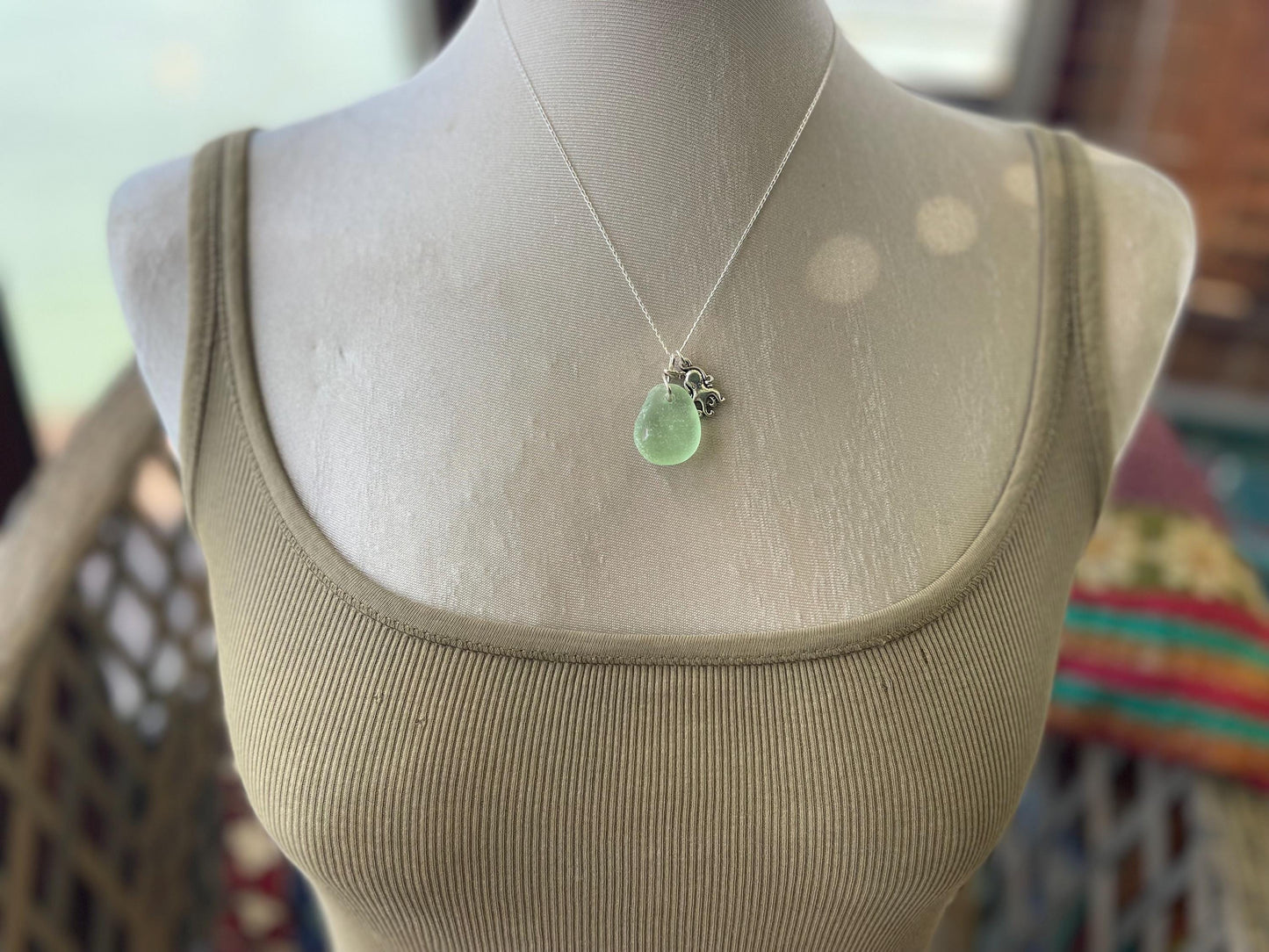 Eco friendly sea glass necklace on a sterling silver chain showcasing a little octopus. Octopus pendant, octopus necklace, eco jewellery