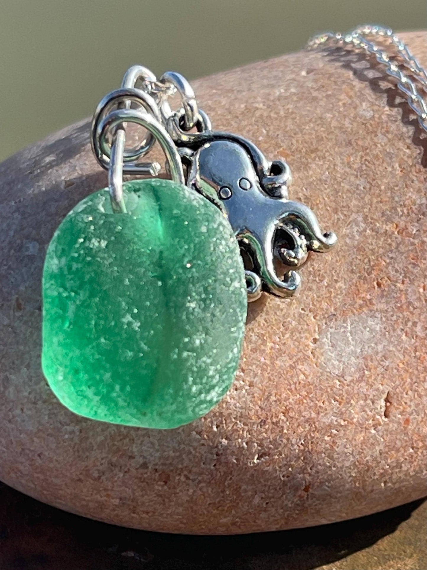 Eco friendly sea glass necklace on a sterling silver chain showcasing a little octopus. Octopus pendant, octopus necklace, eco jewellery