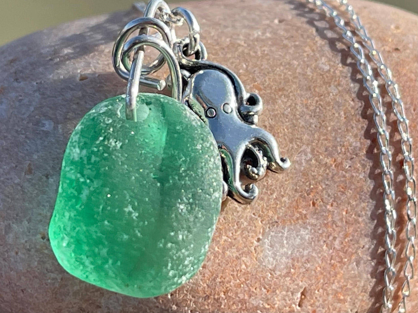 Eco friendly sea glass necklace on a sterling silver chain showcasing a little octopus. Octopus pendant, octopus necklace, eco jewellery