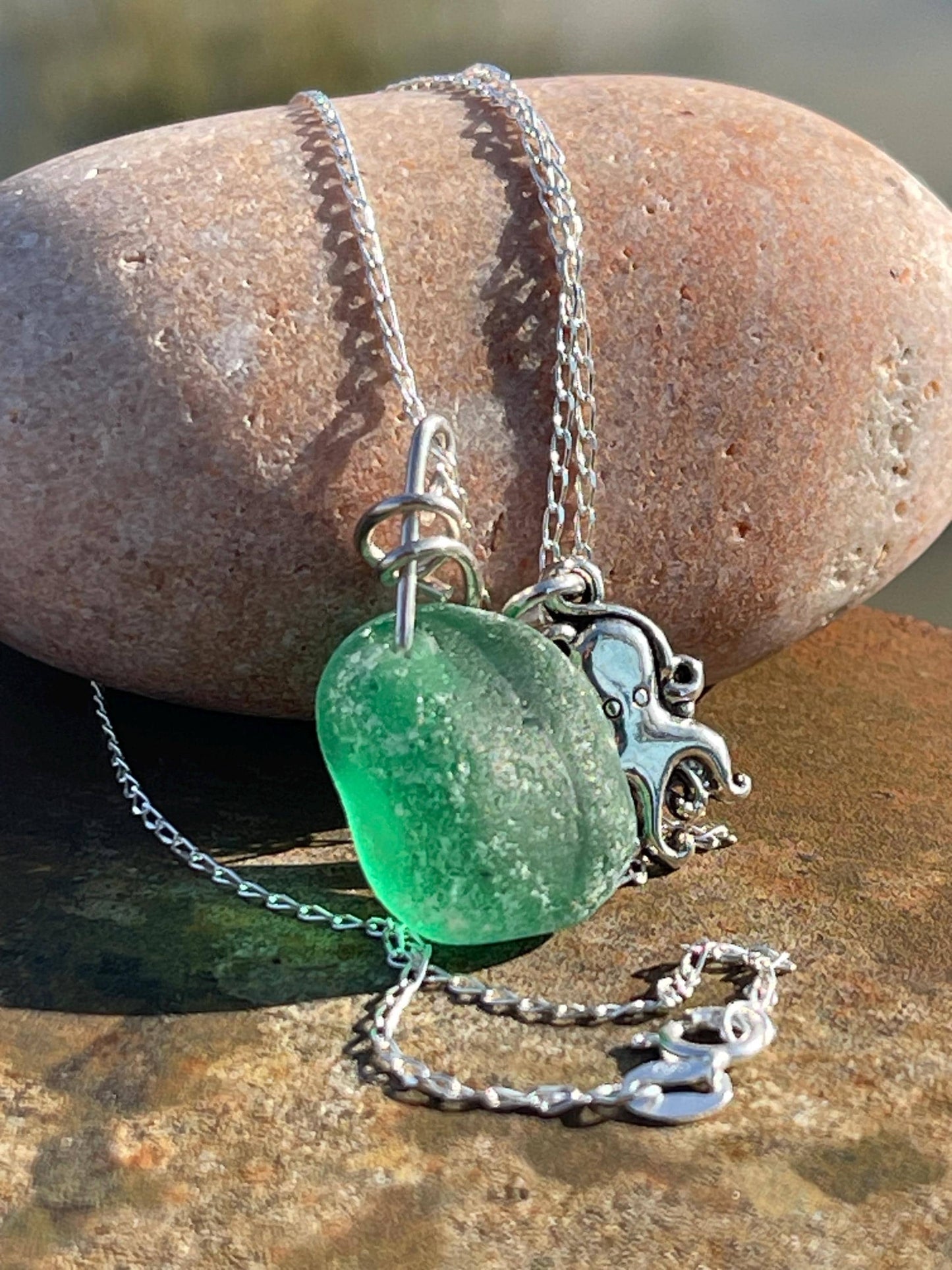 Eco friendly sea glass necklace on a sterling silver chain showcasing a little octopus. Octopus pendant, octopus necklace, eco jewellery