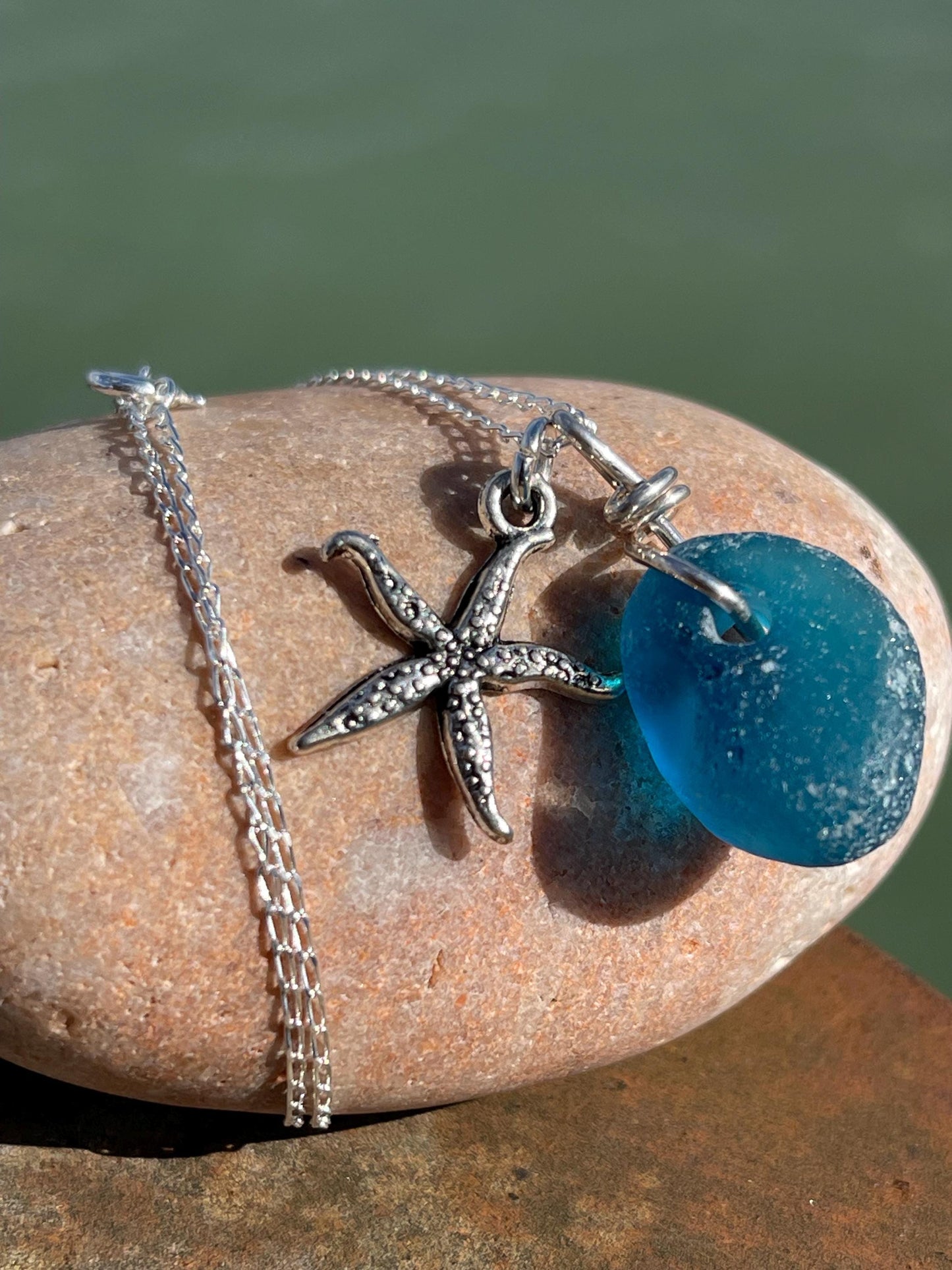 Eco friendly sea glass necklace on a sterling silver chain showcasing a little starfish. Starfish pendant, ethical jewellery. Sea swimming
