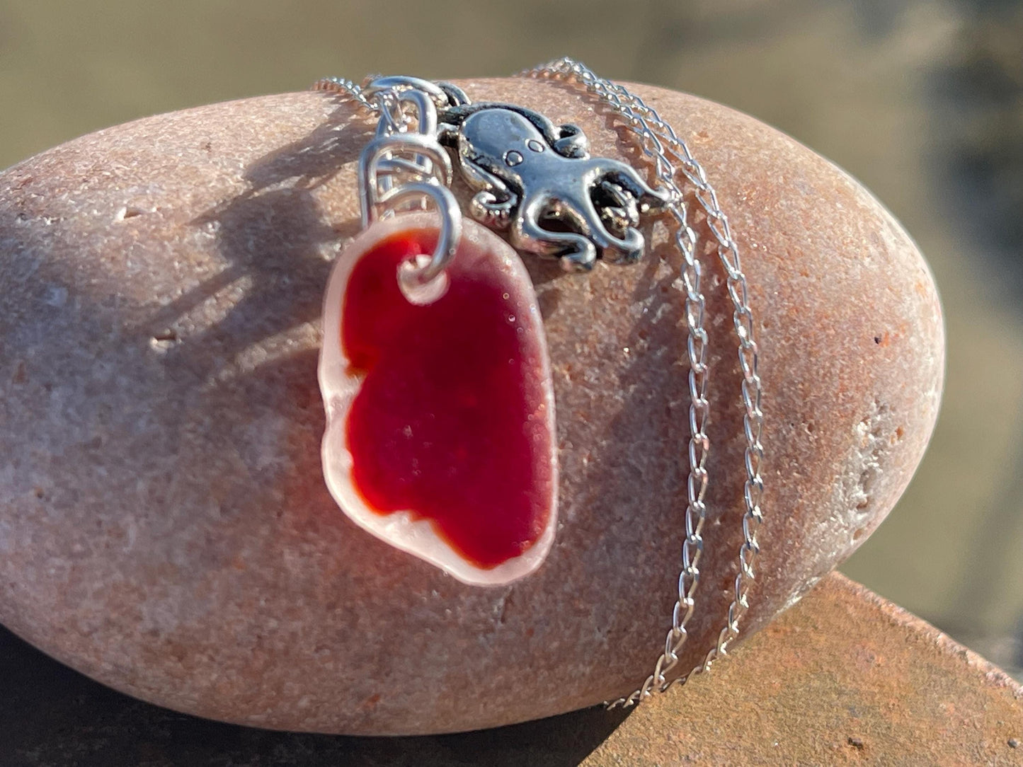 Eco friendly sea glass necklace on a sterling silver chain showcasing a little octopus. Octopus pendant, octopus necklace, ethical jewellery