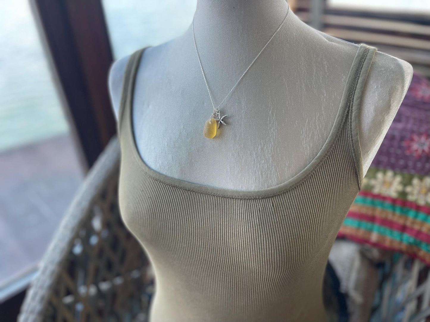 Eco friendly sea glass necklace on a sterling silver chain showcasing a little starfis. Starfish pendant, octopus necklace, eco jewellery