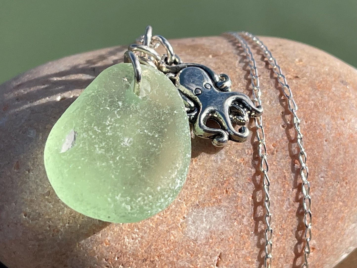 Eco friendly sea glass necklace on a sterling silver chain showcasing a little octopus. Octopus pendant, octopus necklace, eco jewellery