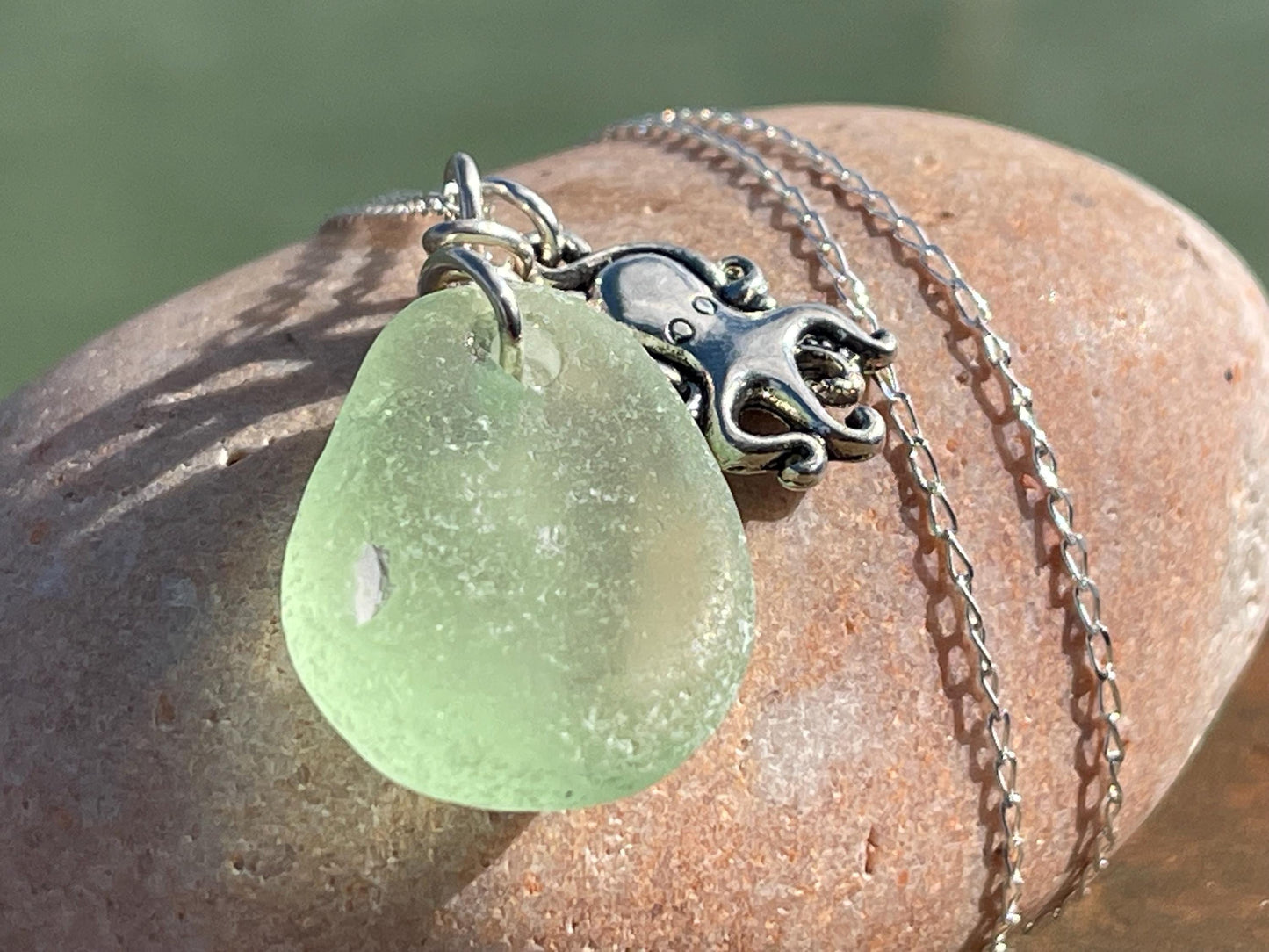 Eco friendly sea glass necklace on a sterling silver chain showcasing a little octopus. Octopus pendant, octopus necklace, eco jewellery