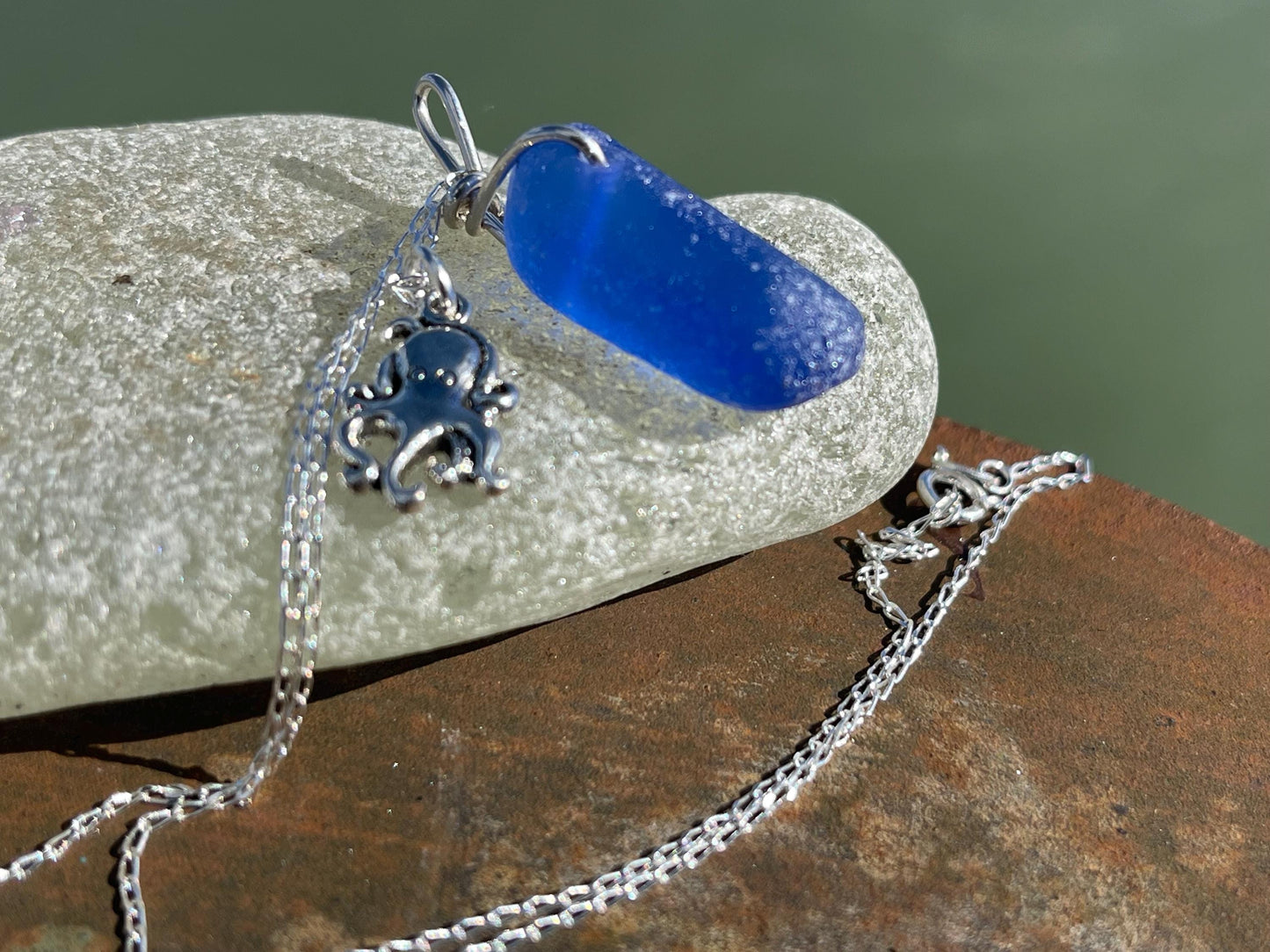 Eco friendly sea glass necklace on a sterling silver chain showcasing a little octopus. Octopus pendant, octopus necklace, ethical jewellery