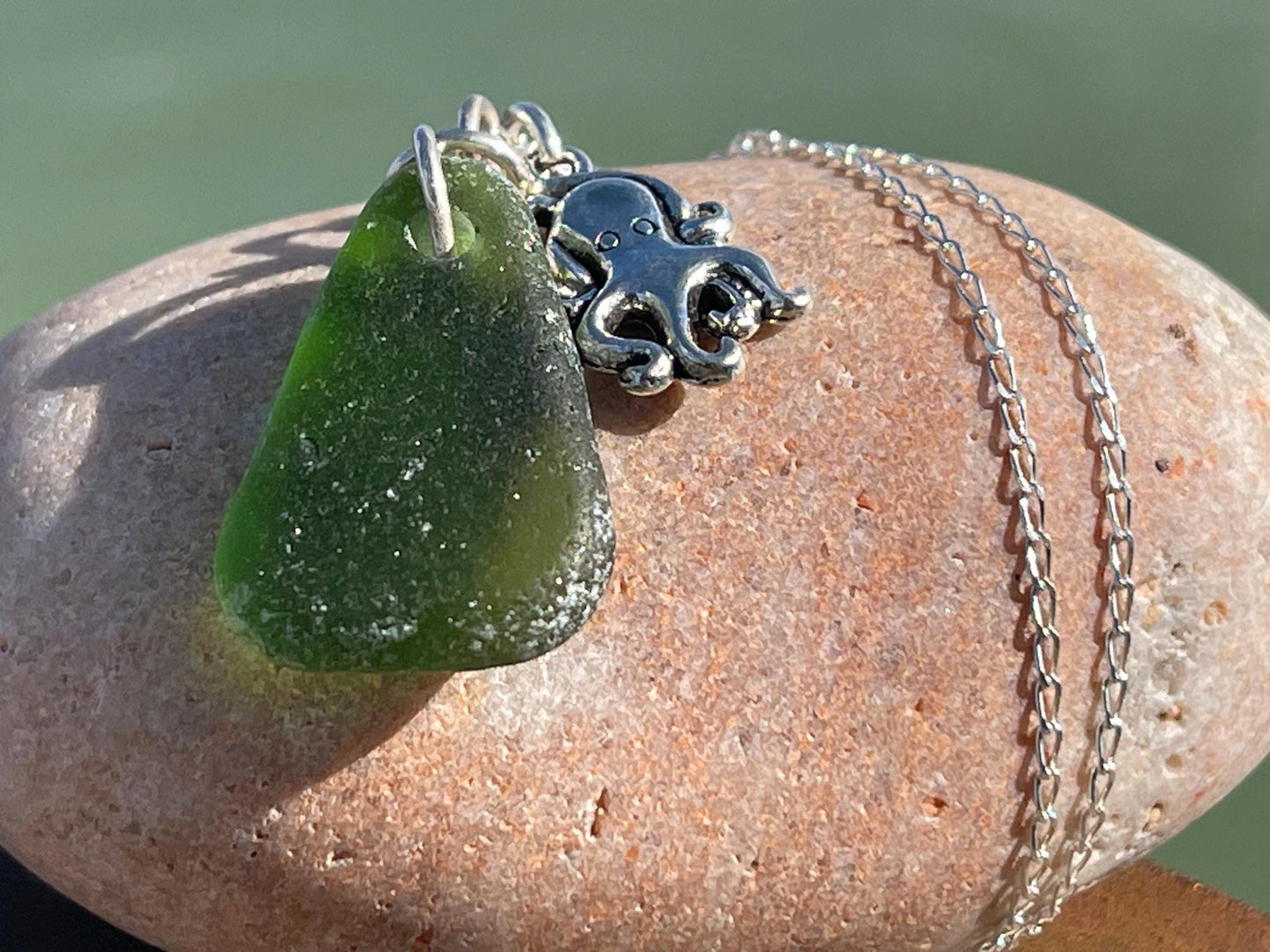 Eco friendly sea glass necklace on a sterling silver chain showcasing a little octopus. Octopus pendant, octopus necklace, ethical jewellery