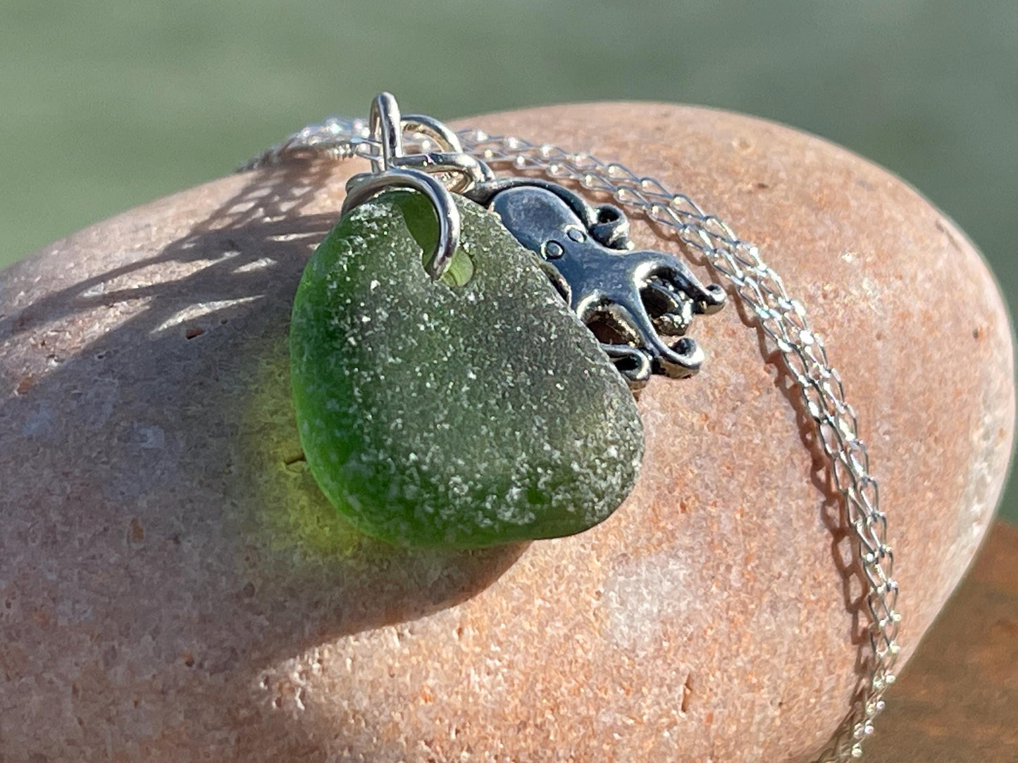 Eco friendly sea glass necklace on a sterling silver chain showcasing a little octopus. Octopus pendant, octopus necklace, ethical jewellery