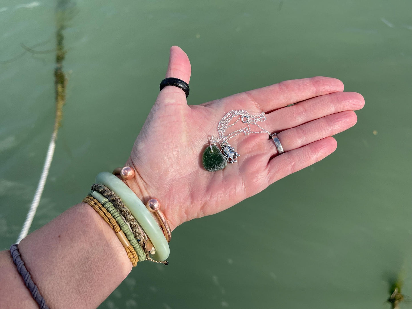 Eco friendly sea glass necklace on a sterling silver chain showcasing a little octopus. Octopus pendant, octopus necklace, ethical jewellery