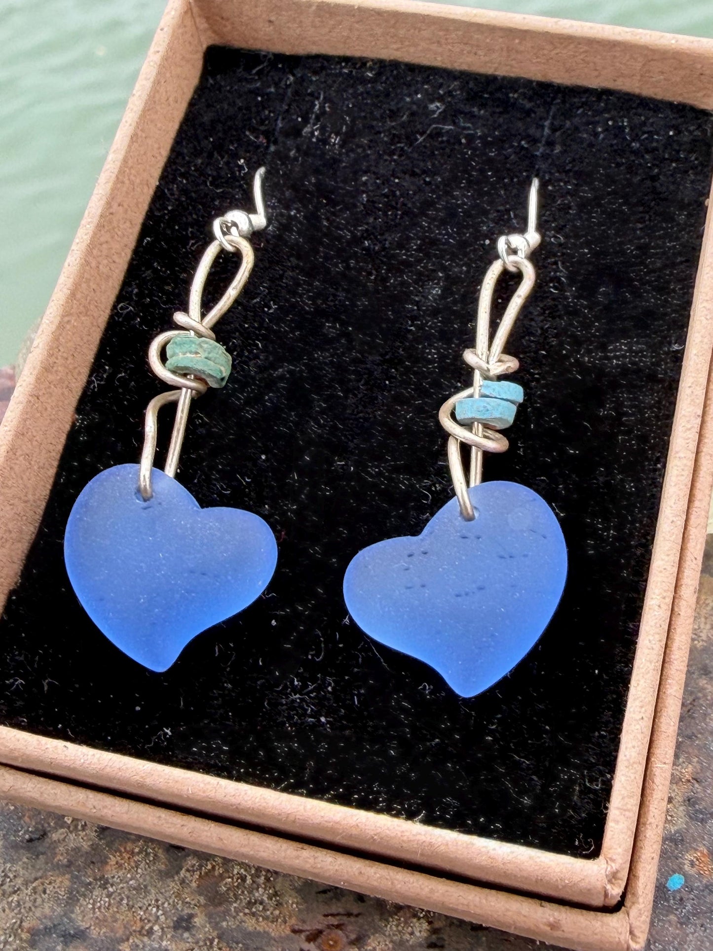 Blue glass heart earrings on recycled sterling silver. Eco conscious jewellery. Ethical jewellery. Blue glass hearts. Handmade earrings