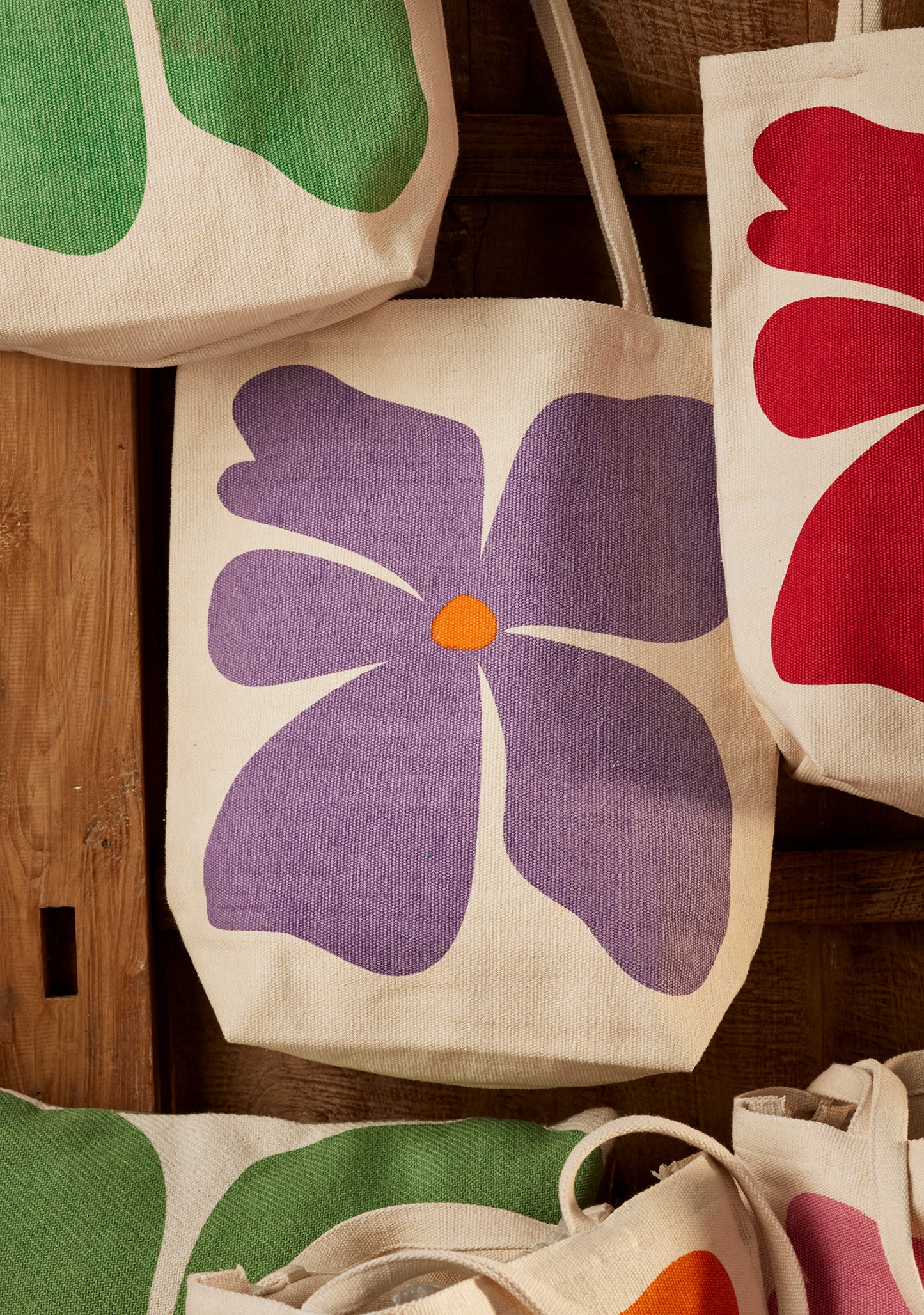Bright joyful recycled cotton bags with bold flower prints. Long handles. Thick strong cotton.