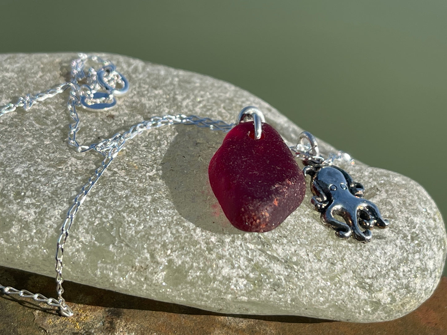 Eco friendly sea glass necklace on a sterling silver chain showcasing a little octopus. Octopus pendant, octopus necklace, ethical jewellery