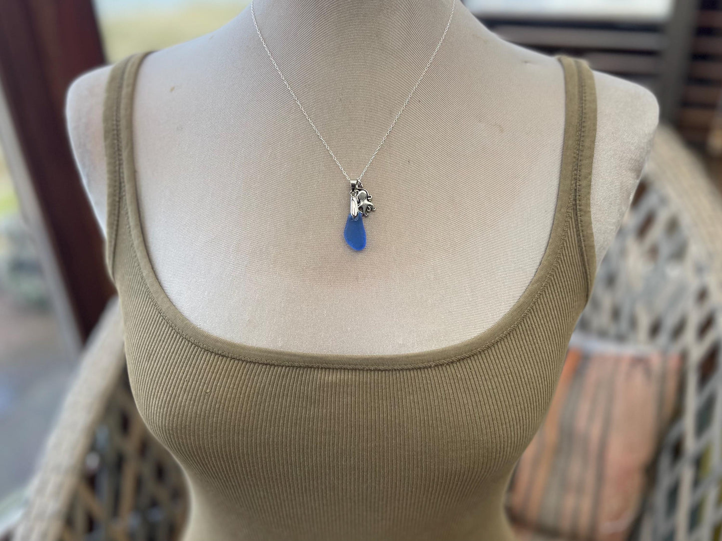 Eco friendly sea glass necklace on a sterling silver chain showcasing a little octopus. Octopus pendant, octopus necklace, ethical jewellery