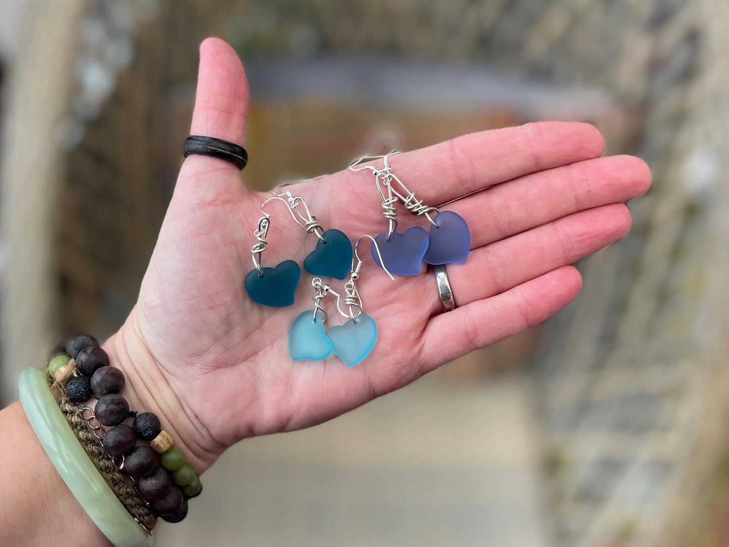Sea glass heart earrings iron recycled sterling silver. Eco conscious jewellery. Ethical jewellery. Blue sea glass hearts. Handmade earrings