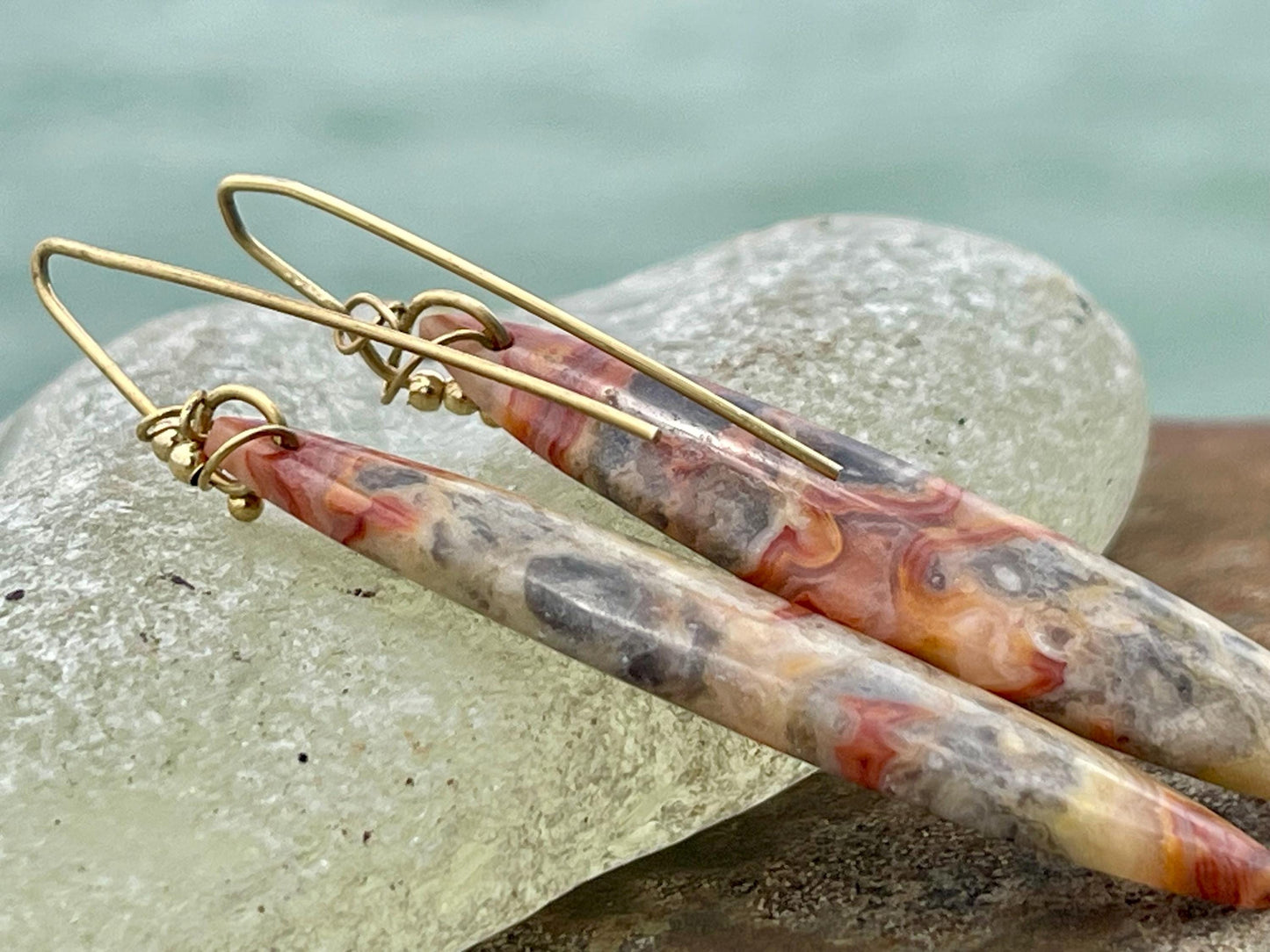 Orange gemstone earrings on recycled sterling silver. Long drop dangly earrings. Unusual orange jewellery. Earthy and ethical jewellery.