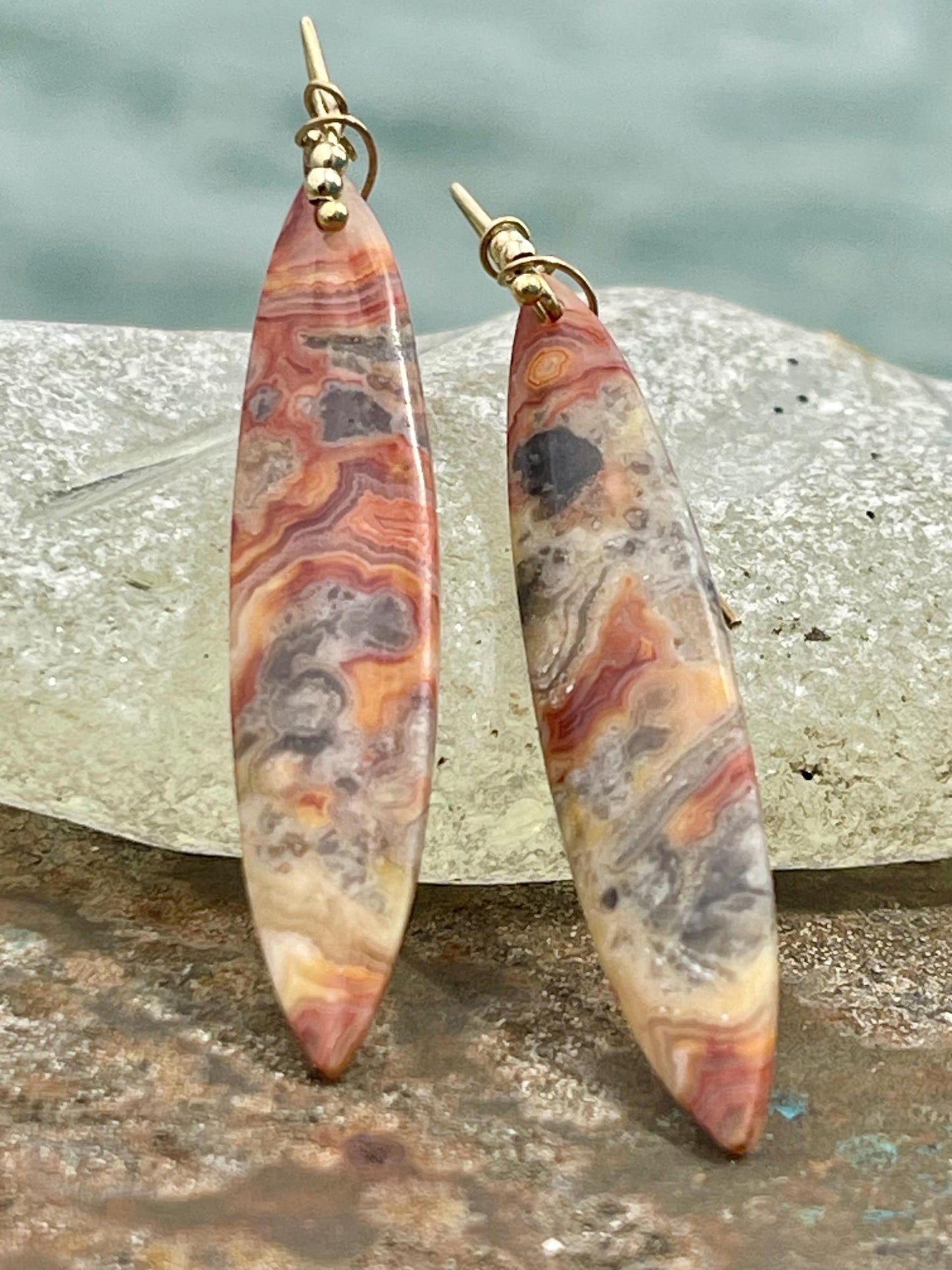 Orange gemstone earrings on recycled sterling silver. Long drop dangly earrings. Unusual orange jewellery. Earthy and ethical jewellery.