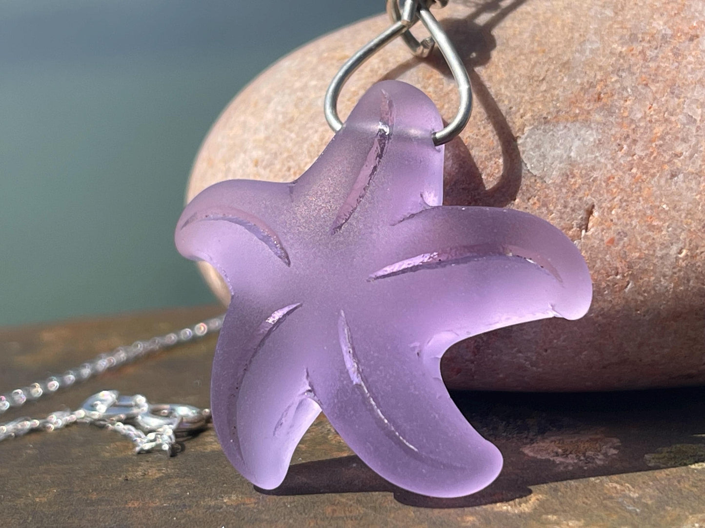 Eco friendly glass necklace on a sterling silver chain showcasing a pink starfish pendant, starfish  necklace, ethical jewellery