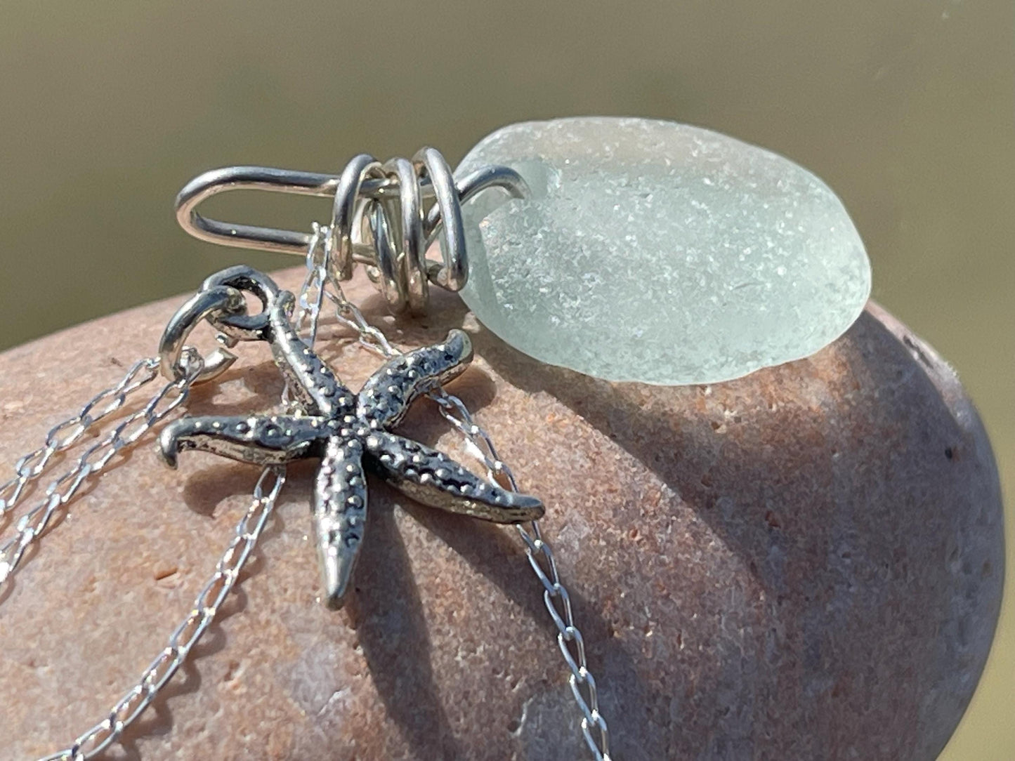 Eco friendly sea glass necklace on a sterling silver chain showcasing a little starfish pendant, starfish  necklace, ethical jewellery