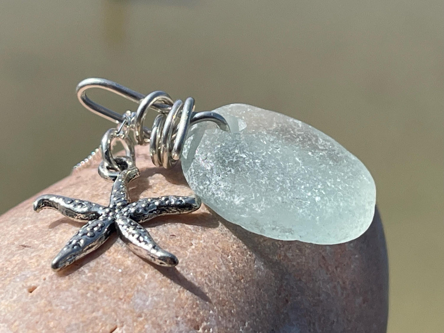 Eco friendly sea glass necklace on a sterling silver chain showcasing a little starfish pendant, starfish  necklace, ethical jewellery