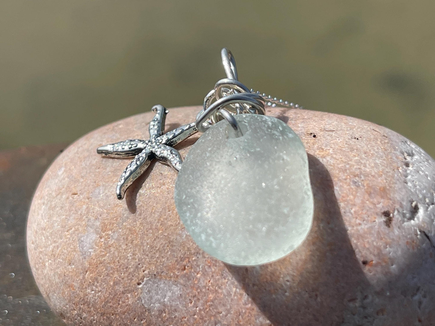 Eco friendly sea glass necklace on a sterling silver chain showcasing a little starfish pendant, starfish  necklace, ethical jewellery