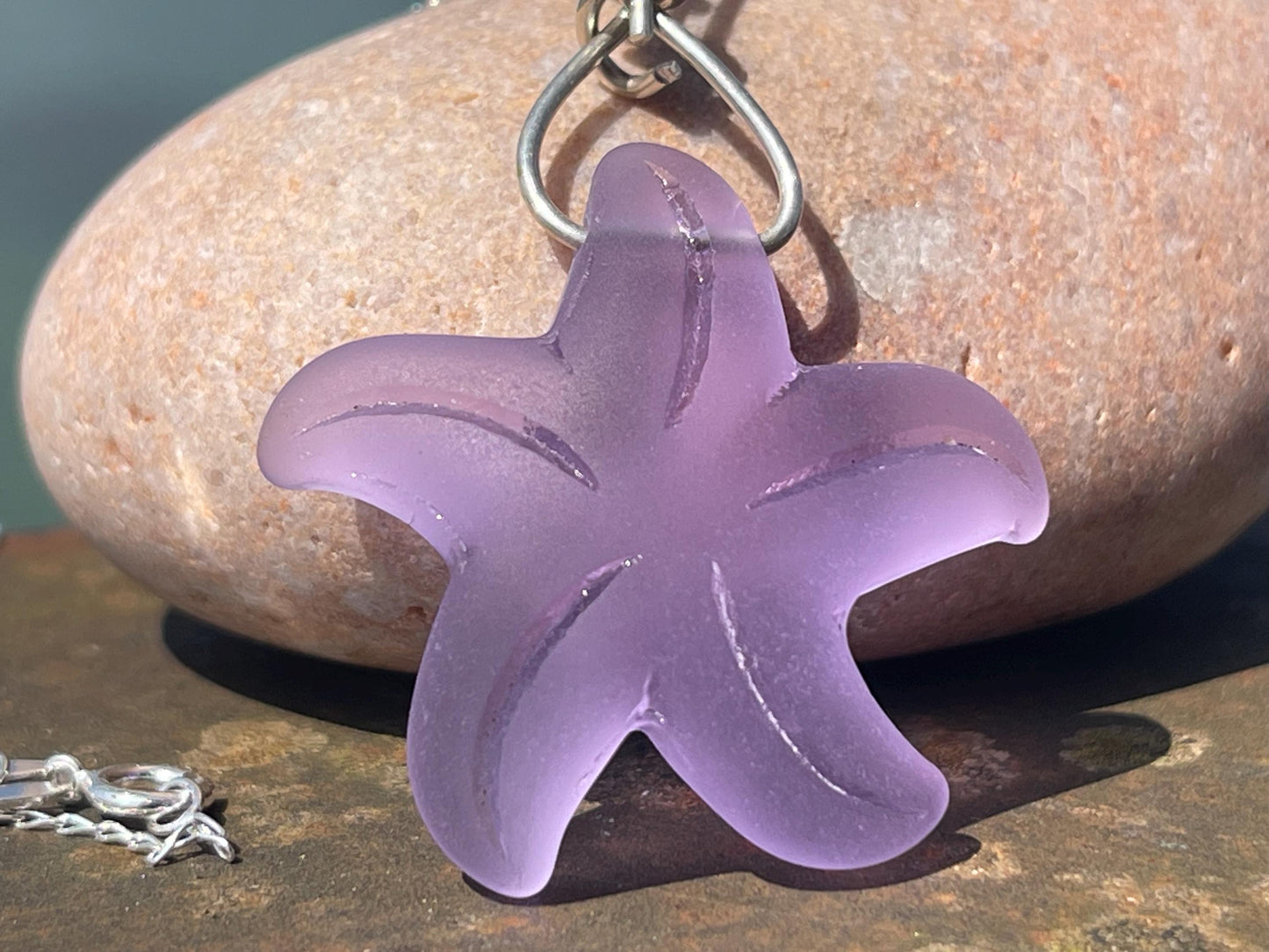 Eco friendly glass necklace on a sterling silver chain showcasing a pink starfish pendant, starfish  necklace, ethical jewellery