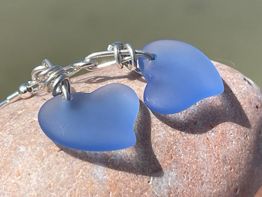 Sea glass heart earrings on recycled sterling silver. Eco conscious jewellery. Ethical jewellery. Blue sea glass hearts. Handmade earrings