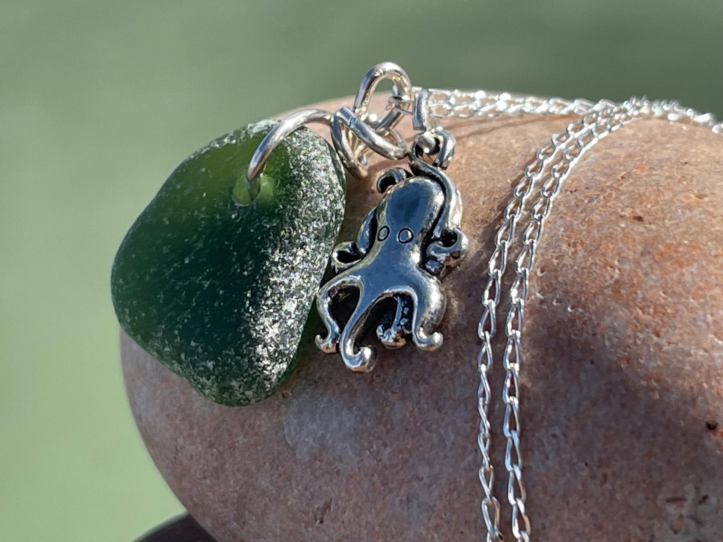 Eco friendly sea glass necklace on a sterling silver chain showcasing a little octopus. Octopus pendant, octopus necklace, ethical jewellery