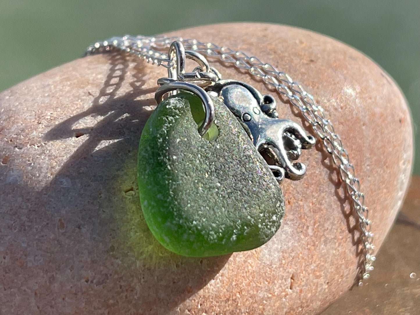 Eco friendly sea glass necklace on a sterling silver chain showcasing a little octopus. Octopus pendant, octopus necklace, ethical jewellery