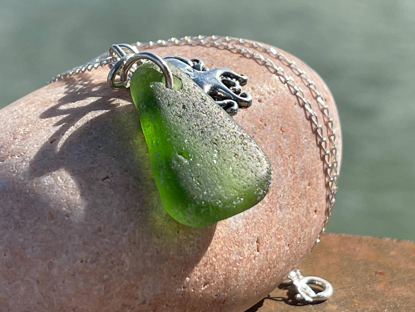 Eco friendly sea glass necklace on a sterling silver chain showcasing a little octopus. Octopus pendant, octopus necklace, ethical jewellery