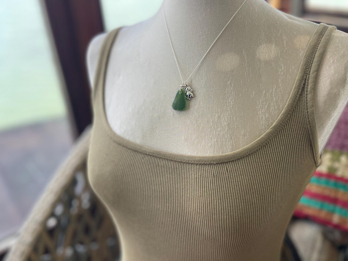 Eco friendly sea glass necklace on a sterling silver chain showcasing a little octopus. Octopus pendant, octopus necklace, ethical jewellery