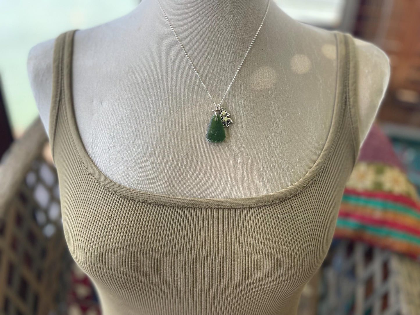 Eco friendly sea glass necklace on a sterling silver chain showcasing a little octopus. Octopus pendant, octopus necklace, ethical jewellery