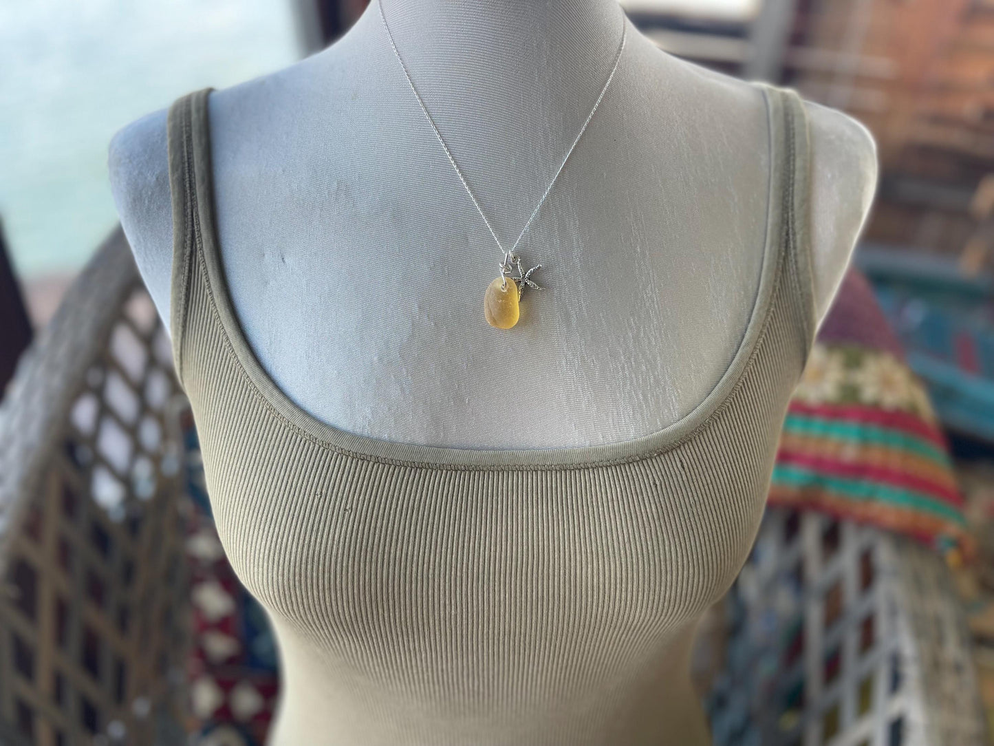 Eco friendly sea glass necklace on a sterling silver chain showcasing a little starfis. Starfish pendant, octopus necklace, eco jewellery