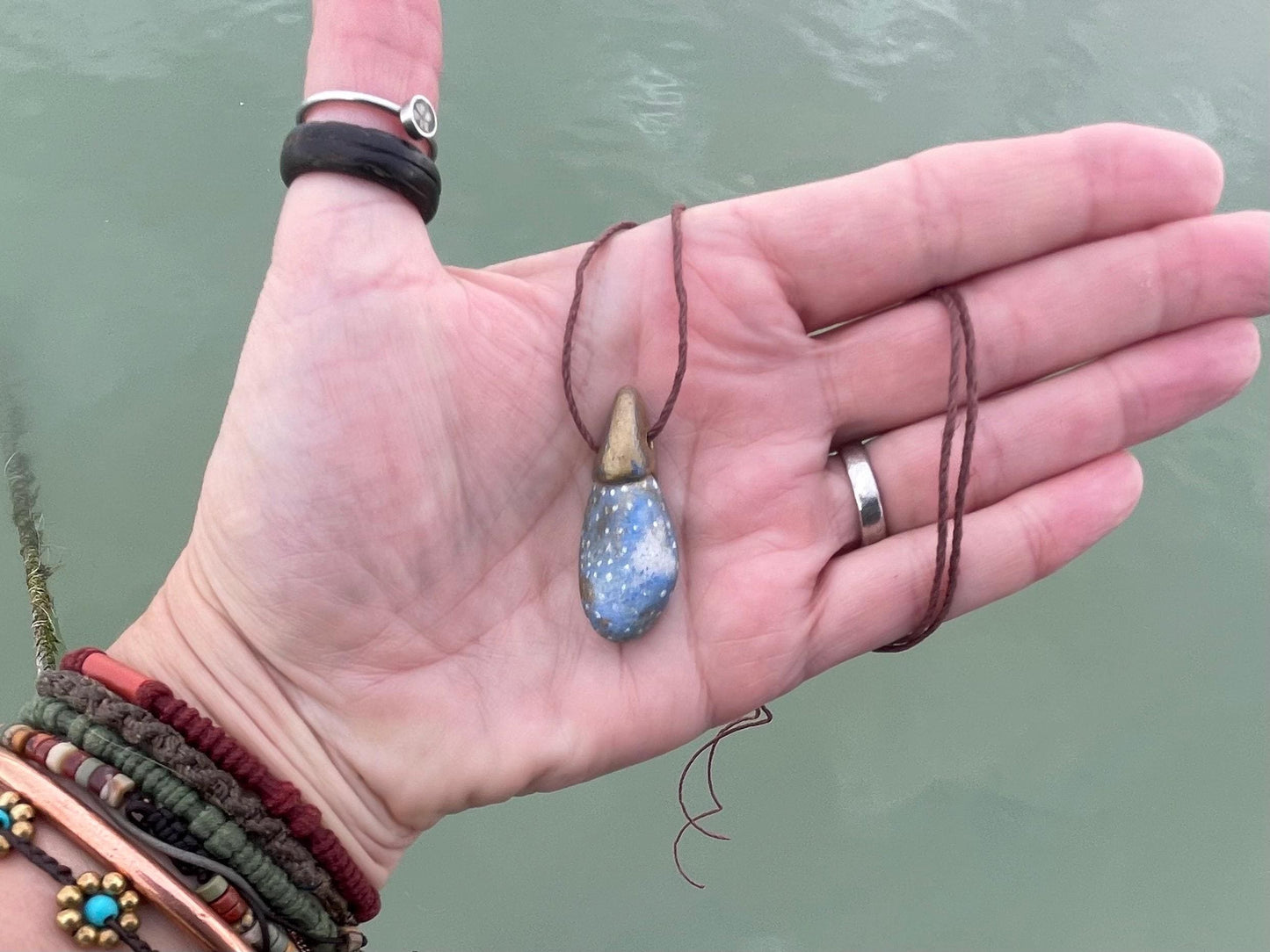 Pebble pendants. Painted pebble necklaces. Hand painted eco friendly necklaces. Eco friendly jewellery. Ethical handmade jewellery.