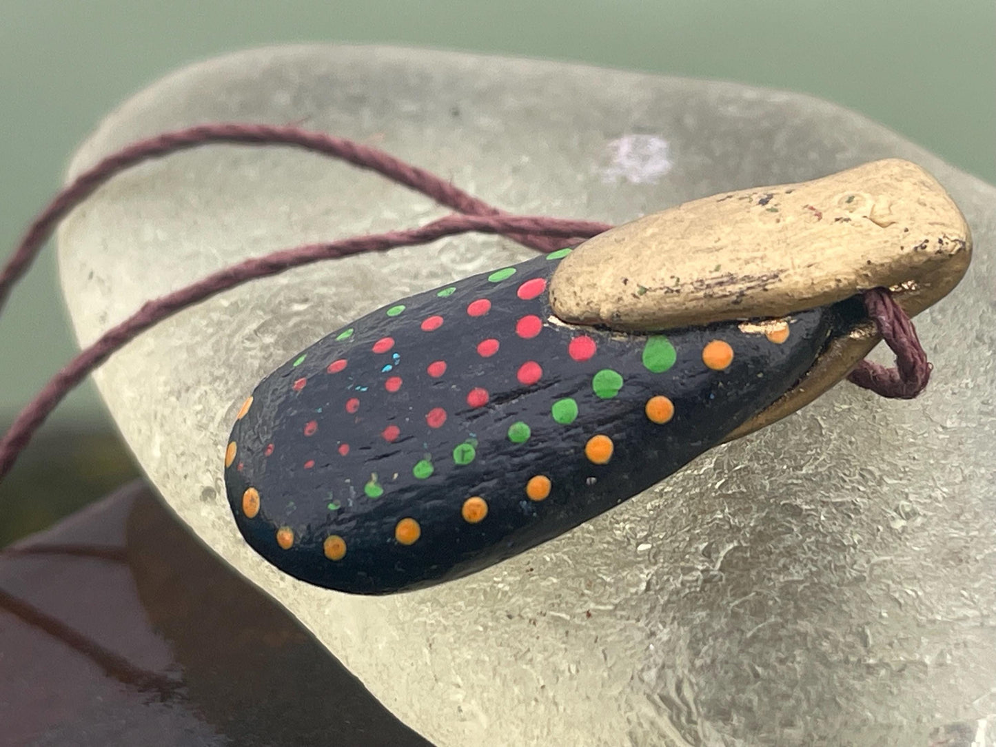 Pebble pendants. Painted pebble necklaces. Hand painted eco friendly necklaces. Eco friendly jewellery. Ethical handmade jewellery.