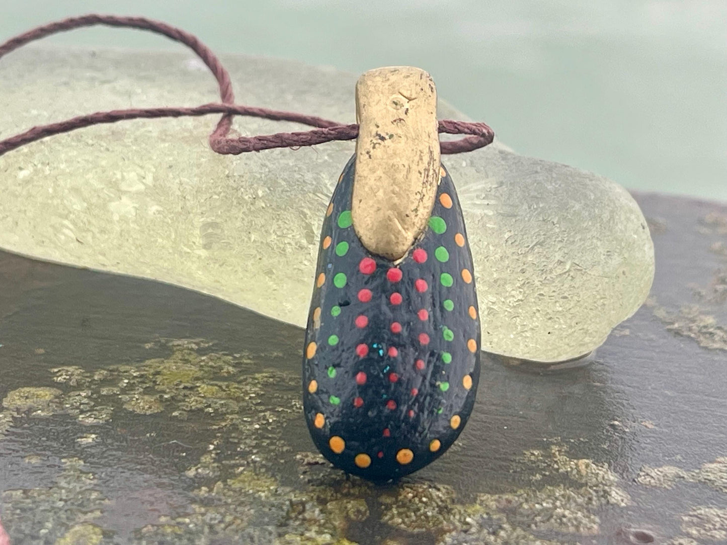 Pebble pendants. Painted pebble necklaces. Hand painted eco friendly necklaces. Eco friendly jewellery. Ethical handmade jewellery.