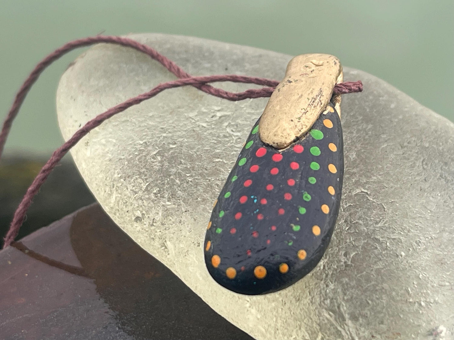 Pebble pendants. Painted pebble necklaces. Hand painted eco friendly necklaces. Eco friendly jewellery. Ethical handmade jewellery.