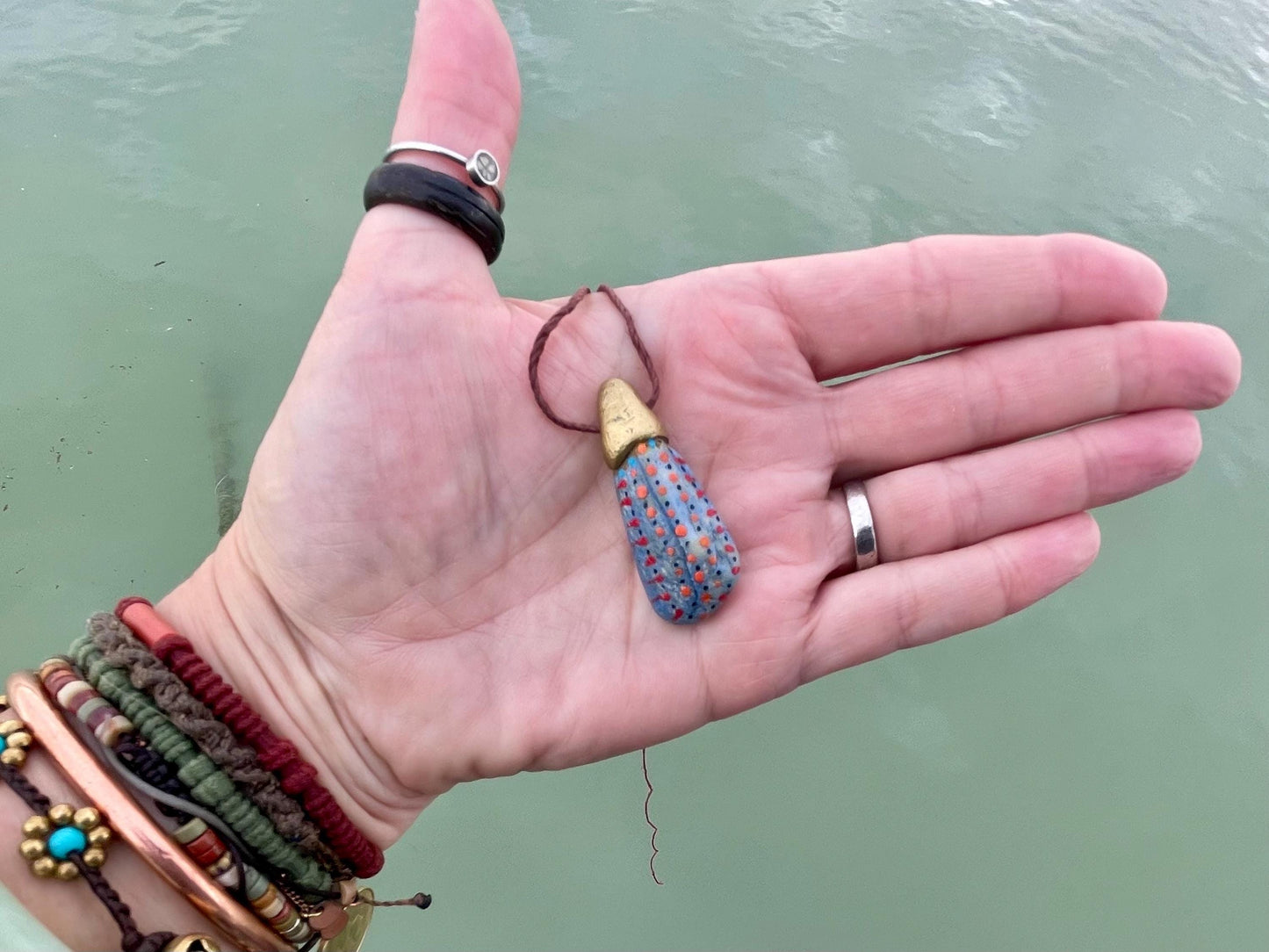 Pebble pendants. Painted pebble necklaces. Hand painted eco friendly necklaces. Eco friendly jewellery. Ethical handmade jewellery.